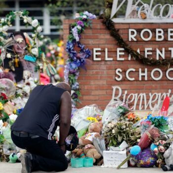 FILE - Reggie Daniels pays his respects a memorial at Robb Elementary School, Thursday, June 9, 2022, in Uvalde, Texas. The 19 fourth-graders and two teachers killed at the elementary school  are being remembered, Friday, May 24, 2024 as the second anniversary of the one of the deadliest school shootings in U.S. history is marked.  (AP Photo/Eric Gay)