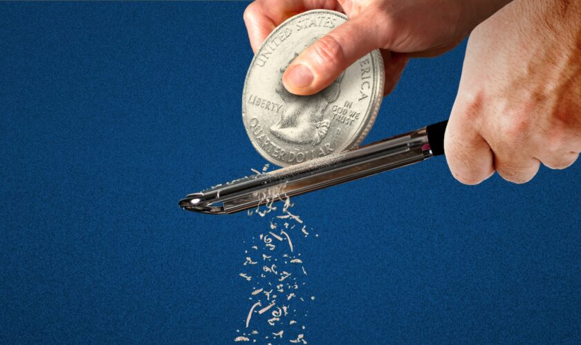 A chef grates a giant quarter coin as though it is Parmesan cheese