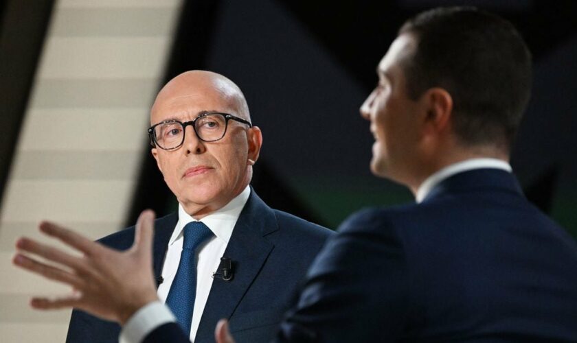 French conservative party Les Republicains (LR) President Eric Ciotti (L) looks at French far-right Rassemblement National (RN) party President Jordan Bardella (R) speaking during a debate as part of the political TV show "L'Evenement" (The Event), focused on pension reform and broadcasted on French TV channel France 2 in Aubervilliers on the northern outskirts of Paris, on February 2, 2023. Faced with growing opposition to her pension reform, France's Prime Minister Elisabeth Borne explained on February 2, 2023 evening on France 2 the meaning of her project, which she defends as "fair" even if it requires an "effort", to convince the French, including in her majority. (Photo by Emmanuel DUNAND / AFP)