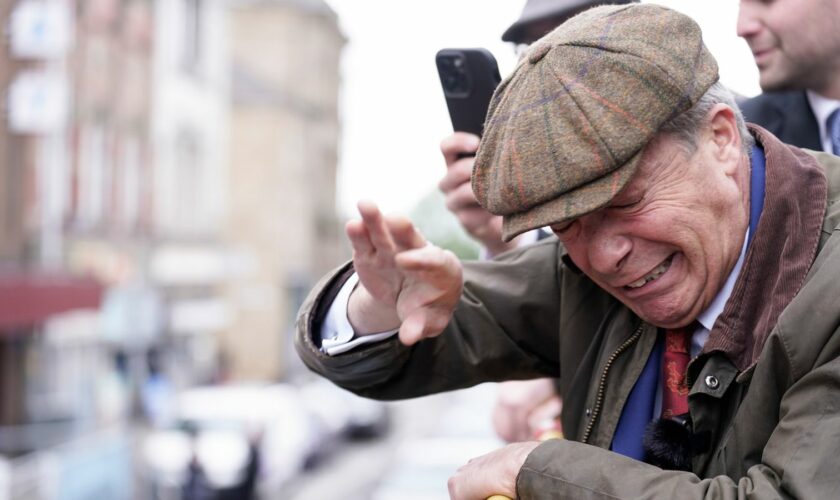 Farage takes cover on open-top bus as man throws objects at him