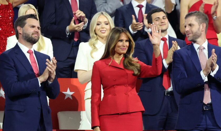 Former first lady Melania Trump waves as she is flanked by vice presidential nominee Senator J.D. Vance (R-OH) and Donald Trump Jr., as Republican presidential nominee and former U.S. President Donald Trump speaks on Day 4 of the Republican National Convention (RNC), at the Fiserv Forum in Milwaukee, Wisconsin, U.S., July 18, 2024. REUTERS/Andrew Kelly