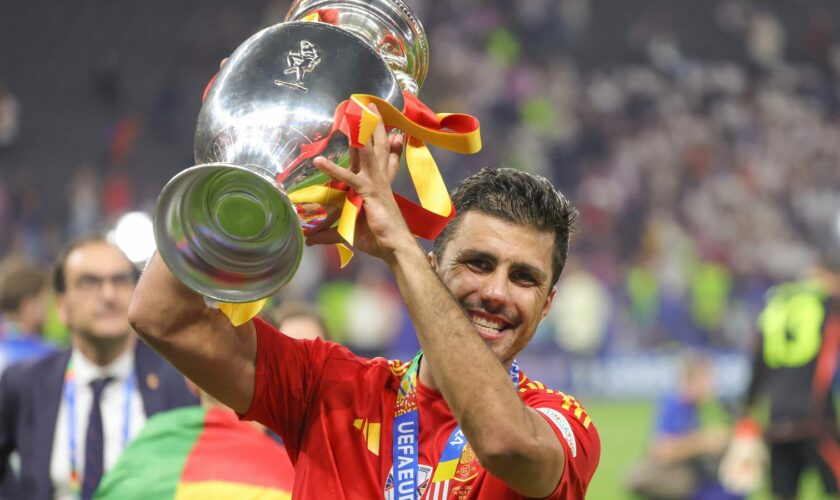 Rodri celebrates with the trophy after Spain won Euro 2024. Pic: AP