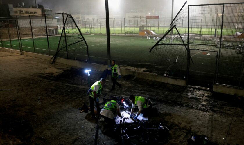 Emergency personnel inspect the area attacked in the Golan Heights. Pic: Reuters