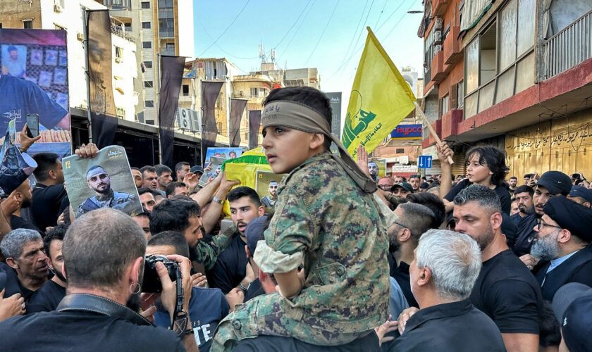 A child on a man's shoulders at a Hezbollah funeral in Beirut, Lebanon