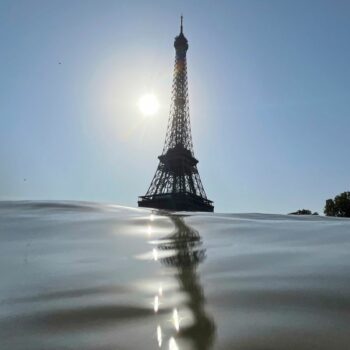 30 July 2024, France, Paris: Olympics, Paris 2024, triathlon, Olympic distance (swimming, 40 km cycling, 10 km running), men, the Eiffel Tower can be seen behind the Seine. (to "River water too dirty: men's triathlon postponed") Photo by: Jan Woitas/picture-alliance/dpa/AP Images