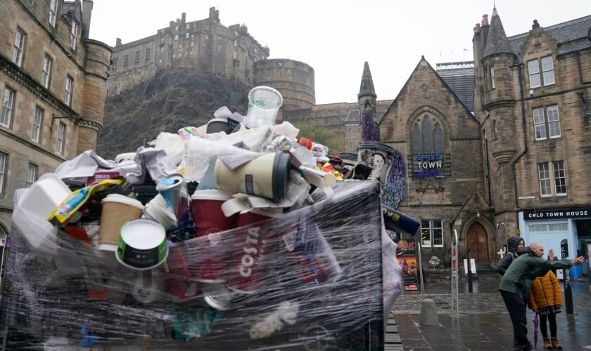 Overflowing bins in the Grassmarket area of Edinburgh where cleansing workers from the City of Edinburgh Council are on the fourth day of eleven days of strike action. Workers at waste and recycling depots across the city have rejected a formal pay offer of 3.5 percent from councils body Cosla. Picture date: Wednesday August 24, 2022.