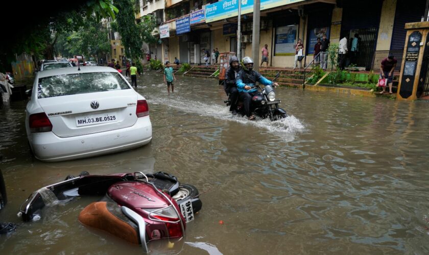 Across river from lavish Indian wedding, frustration and flooded streets