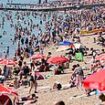 Brits bask in temperatures of 32C in hottest day of the year so far as Met Office issues official heatwave warning - but storms are on the way within hours