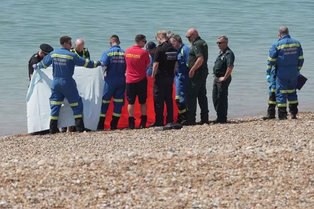 Seaford beach chaos as man's body found with black tarpaulin sheets across sand