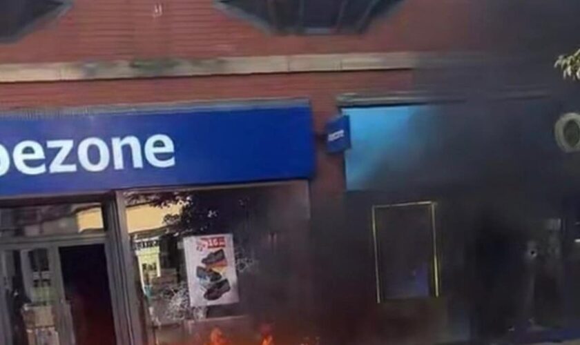 Far-right rioters loot shops and set fire to library and food bank in shameless day of disorder