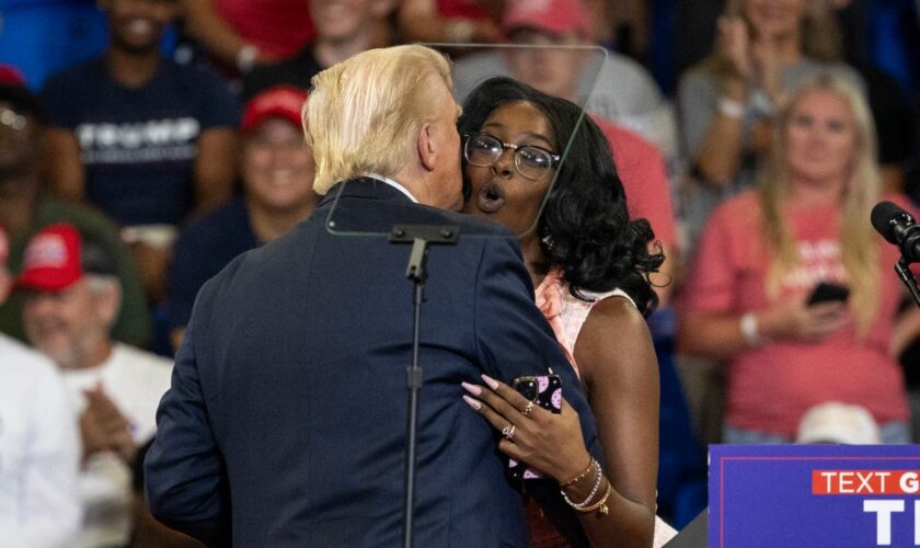 Trump embraces MAGA activist at Atlanta rally who repeats his offensive claims about Harris’ heritage