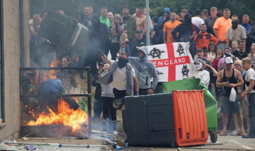 Rioters outside the hotel in Rotherham on Sunday. Pic: Reuters