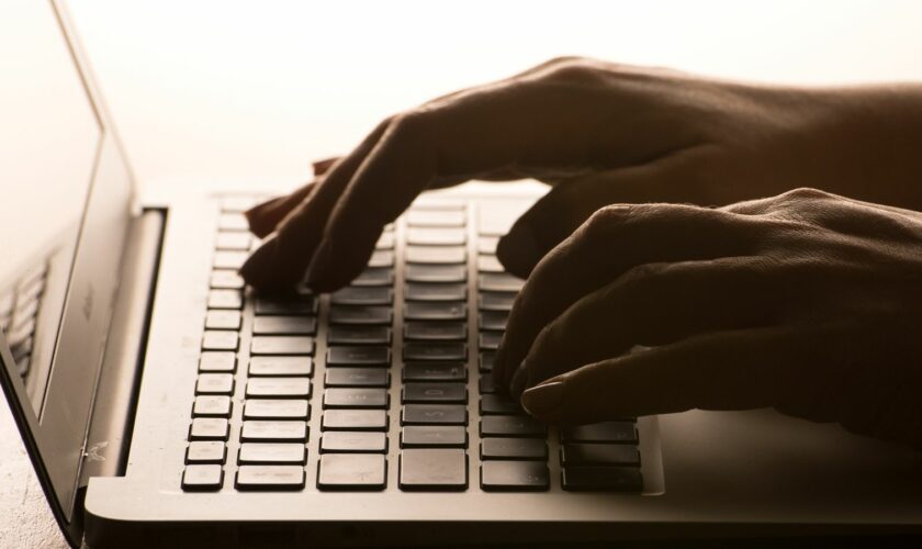 File photo dated 04/03/2017 of a woman's hands on a laptop keyboard. File pic: PA