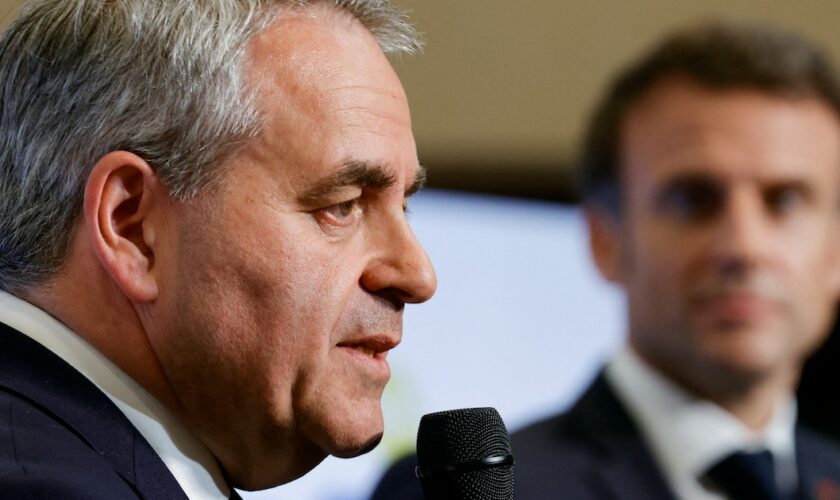 President of the Regional Council of Hauts-de-France Xavier Bertrand (L) speaks next to French President Emmanuel Macron at the Dunkirk Urban Community offices in Dunkerque, the city picked by Taiwanese company ProLogium to build a battery gigafactory plant, northern France, on May 12, 2023. (Photo by PASCAL ROSSIGNOL / POOL / AFP)