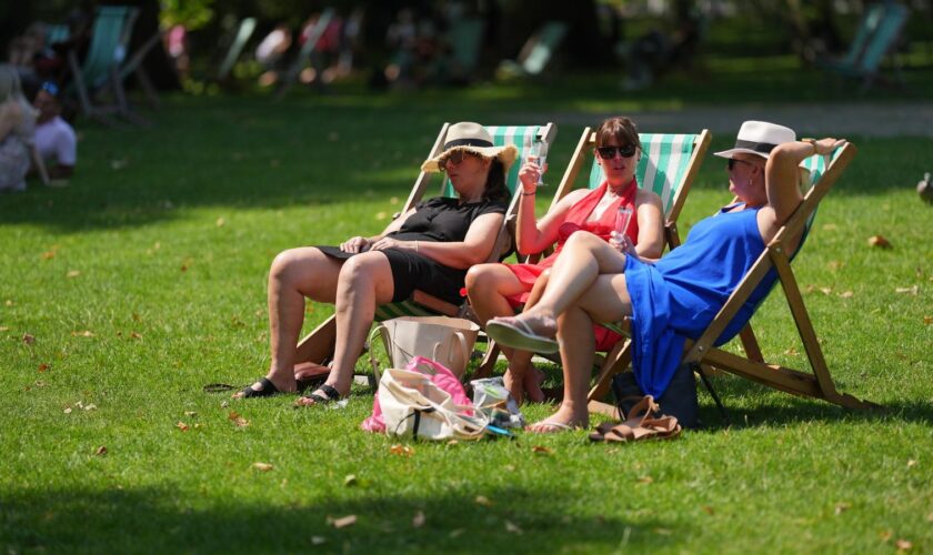 People enjoy the warm weather in St James' Park, London. Picture date: Friday August 2, 2024.