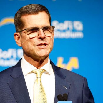 Chargers coach Jim Harbaugh to serve as honorary captain at Michigan's season opener despite NCAA penalties