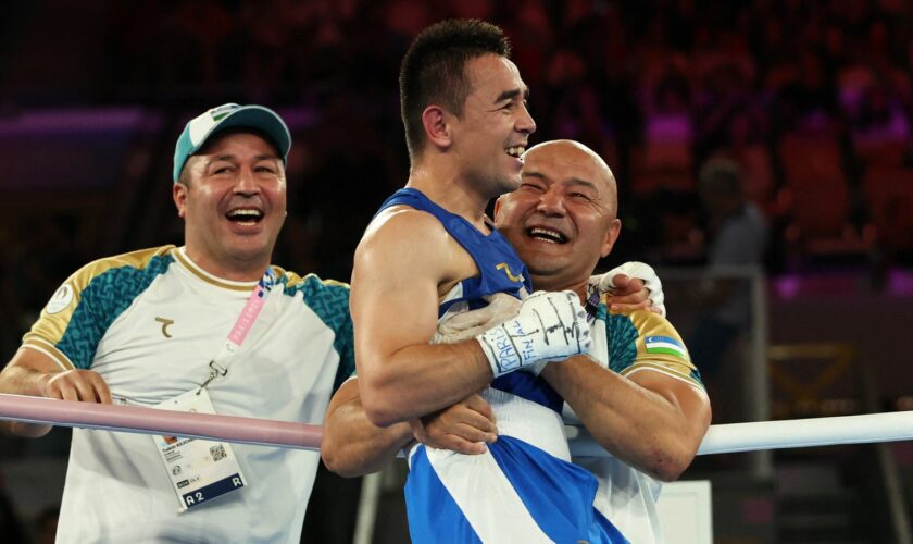 Paris 2024 Olympics - Boxing - Men's 51kg - Final - Roland-Garros Stadium, Paris, France - August 08, 2024. Hasanboy Dusmatov of Uzbekistan celebrates with coaching staff after winning against Billal Bennama of France. REUTERS/Maye-E Wong