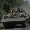 Ukrainian servicemen ride a military vehicle near the Russian border. Pic: Reuters