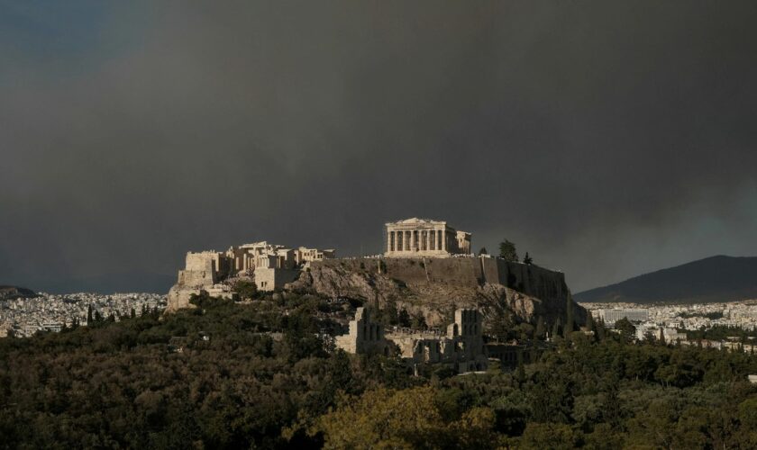 The Parthenon temple atop the Acropolis hill as smoke from a wildfire is seen, in Athens Greece, August 11, 2024. REUTERS/Elias Marcou TPX IMAGES OF THE DAY