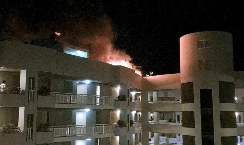 The fire burning on the DoubleTree Hotel after the helicopter crash. Pic: Reuters