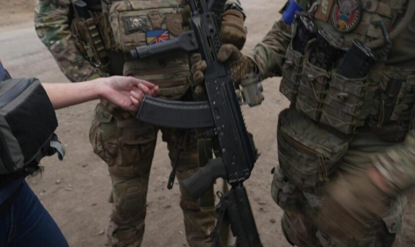 Smiling Ukrainian soldier holds up 'trophy' taken from inside Russia