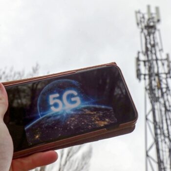 A 5G phone next to a telecoms mast near Wokingham, Berkshire. Pic: PA