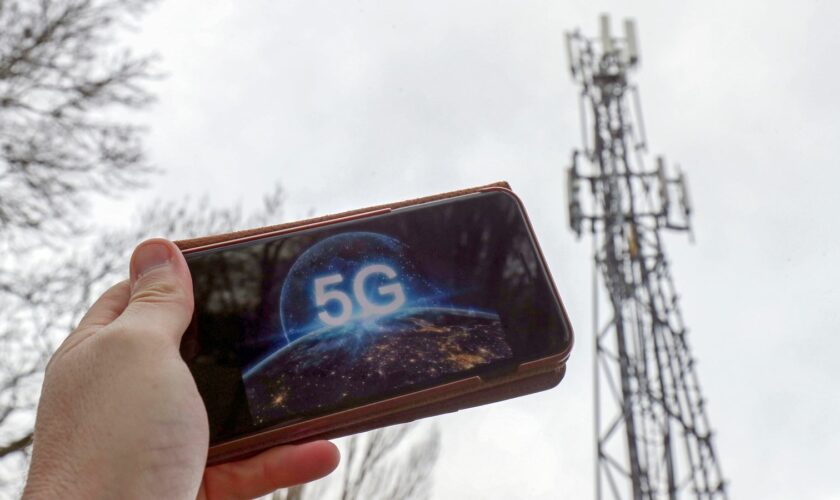 A 5G phone next to a telecoms mast near Wokingham, Berkshire. Pic: PA