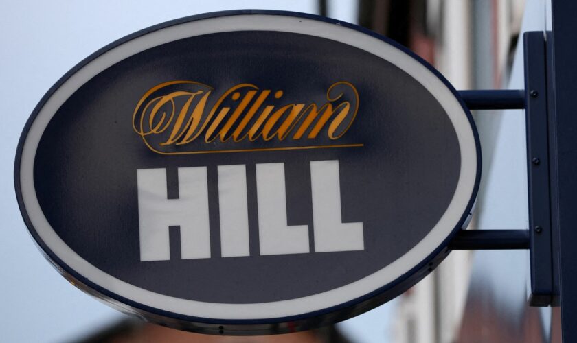 FILE PHOTO: Signage is seen outside a William Hill betting shop in Manchester, Britain March 28, 2023. REUTERS/Phil Noble/File Photo