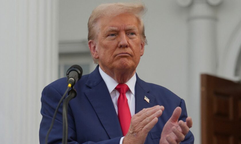 Donald Trump applauds during a press conference at Trump National Golf Club, in Bedminster, New Jersey