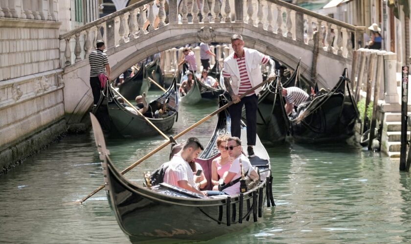 Day-trippers take a gondola tour, on the last day of the experimental 5 euro entry fee to visit Venice, in Venice, Italy, July 14, 2024. REUTERS/Manuel Silvestri