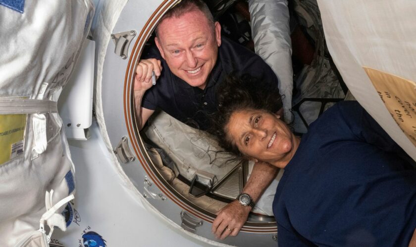 In this photo provided by NASA, Boeing Crew Flight Test astronauts Butch Wilmore, left, and Suni Williams pose for a portrait inside the vestibule between the forward port on the International Space Station's Harmony module and Boeing's Starliner spacecraft on June 13, 2024. (NASA via AP)