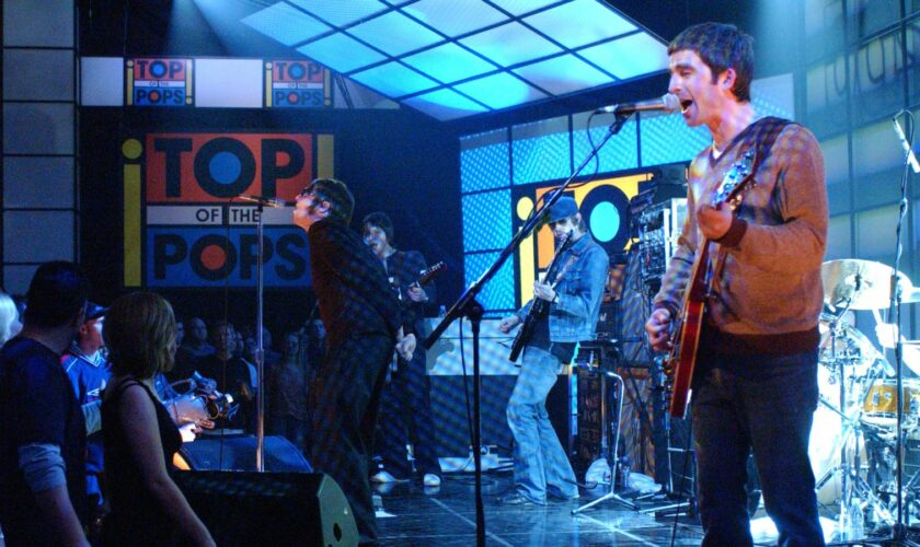 Noel Gallagher, right, and Liam Gallagher, of Oasis, appears on the television show "Top of the Pops" at BBC TV Studios in 2002. (AP Photo/Mark Allan)