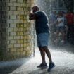 A man refreshes himself at Crown Fountain during a period of hot weather in Chicago, Illinois, U.S. August 26, 2024. REUTERS/Vincent Alban