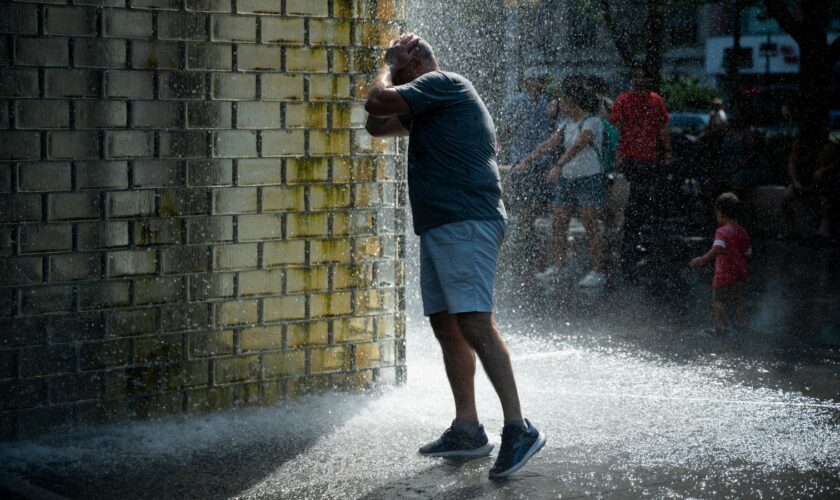 A man refreshes himself at Crown Fountain during a period of hot weather in Chicago, Illinois, U.S. August 26, 2024. REUTERS/Vincent Alban