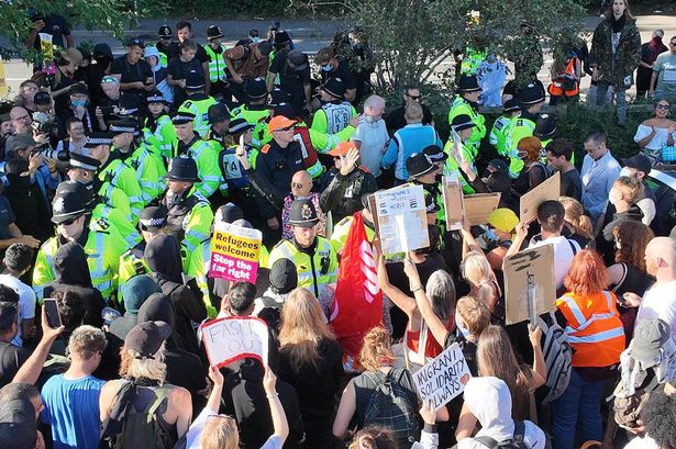 Anti-racism protesters protect Crawley hotel as delighted child waves from window