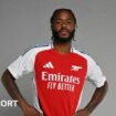 Raheem Sterling poses in an Arsenal shirt