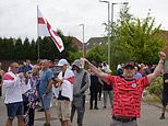 Balaclava-clad protesters swilling beer cans begin demo outside migrant hotel in Rotherham just hours after thugs tore cities apart in violent riots - as Keir Starmer is slammed for going on holiday while Britain burns