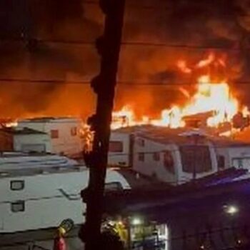 Caravans on fire at Oldham storage yard as dozens of mobile homes at risk of fireball