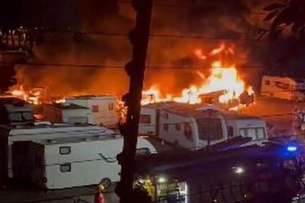 Caravans on fire at Oldham storage yard as dozens of mobile homes at risk of fireball