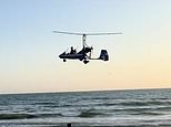 Dramatic moment low-flying gyrocopter crashes into sea near horrified beach sunbathers and swimmers - as officials say it was 'only by chance it did not turn into a tragedy'