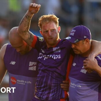 Ben Stokes being carried off the field by two members of Northern Superchargers' staff