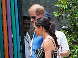 Harry and Meghan kick off the third day of their quasi royal Colombian tour with a visit to a music school while 3,000 police, snipers and a Black Hawk helicopter are called in to protect the couple, despite barely anyone turning up to greet them