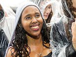 It's really raining in Reading! Music lovers brave the downpours at Berkshire pop gathering - while the sun has been spotted at wind-hit Leeds Festival