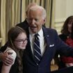 Joe Biden leaves daughter of freed hostage in tears as he awkwardly sings 'Happy Birthday' and hugs her while celebrating prisoner swap with Russia