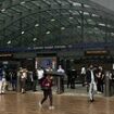 London's Canary Wharf tube station is evacuated after 'man falls from height' with police yelling 'get out as quickly as you can' - as panicked people are seen sprinting away