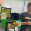 Moment Subway worker launches footlong cookie at dad before he 'returns fire'