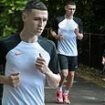 Phil Foden enjoys a run with his son Ronnie, 5, as the Man City star is seen for the first time since neighbours 'called police over late night children's party at his £3M Cheshire mansion'