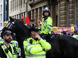 Riots break out in Manchester and Hull as tear gas is fired into crowds and police battle thugs as chaos from protests organised after Southport horror continue across the UK