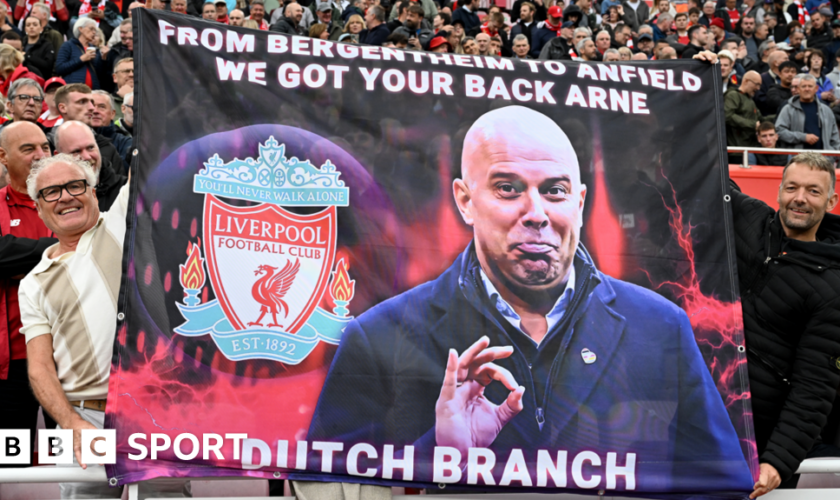 Liverpool fans hold up a banner before Arne Slot's first Premier League game at Anfield