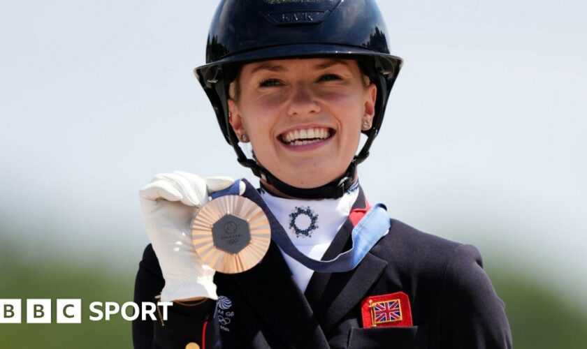 Charlotte Fry poses with her medal after winning the individual dressage bronze at the Paris 2024 Olympics